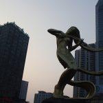 woman statue playing instrument