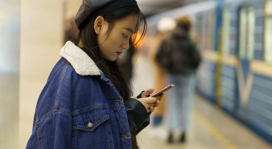 addicted from phone chinese girl pay no attention arriving train platform scroll social media