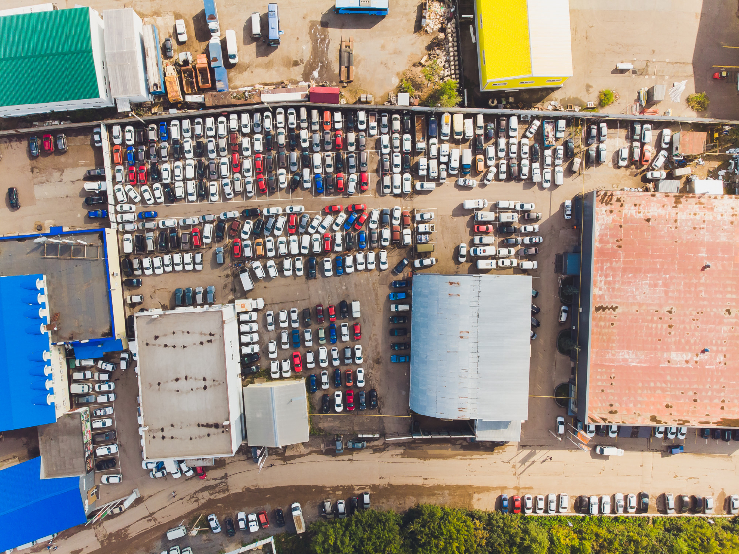 aerial photo small temporary car lot store new cars resale car dealers who have free space storage high altitude top down view