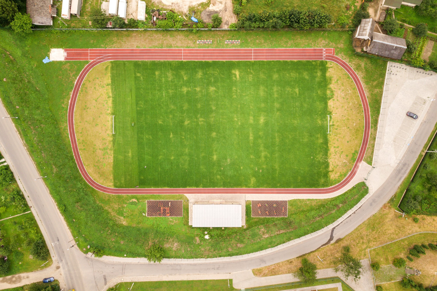 aerial view of school sports oval with running tracks and football field