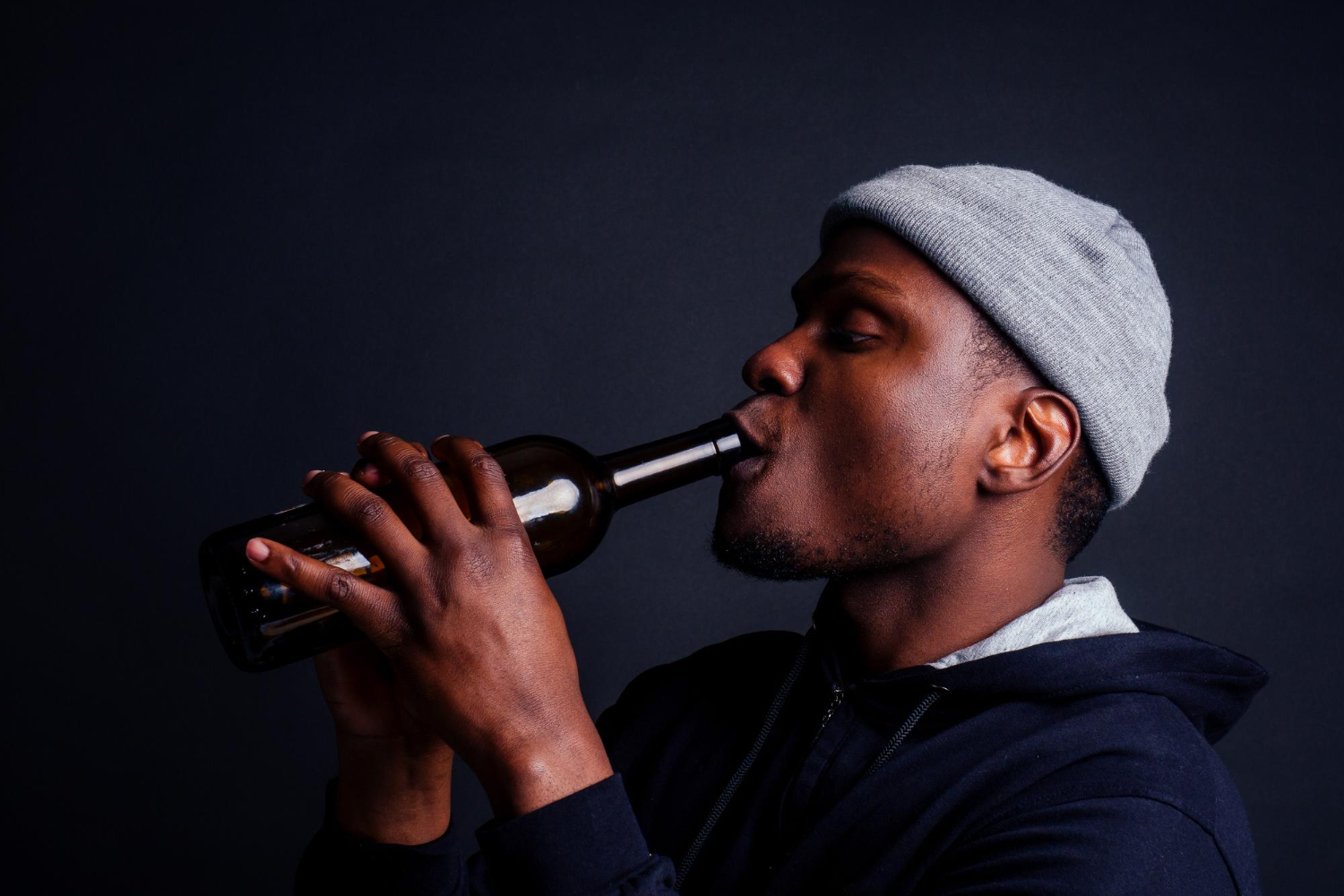 african american gray beanie hoody with beer bottle drinking alcohol