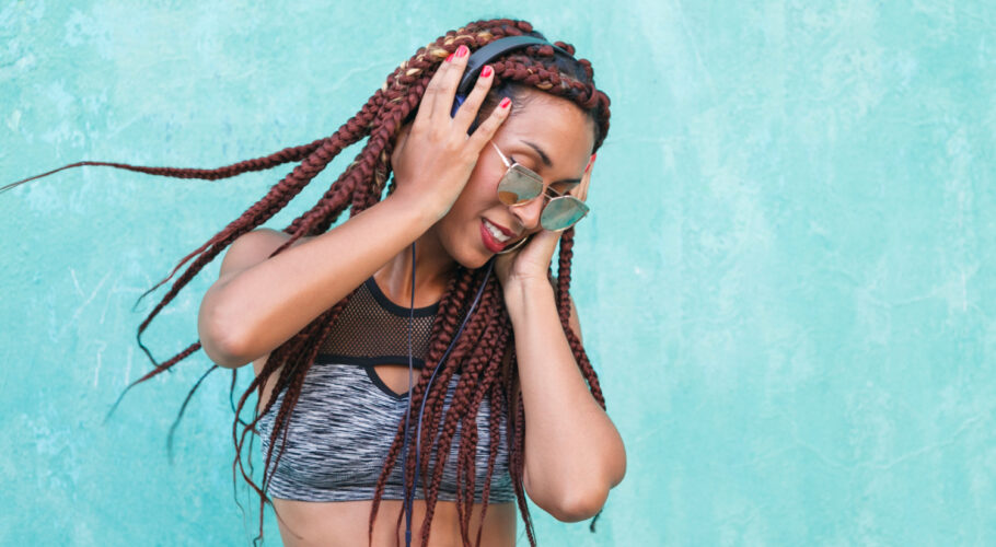 african american woman listening funky playlist her phone