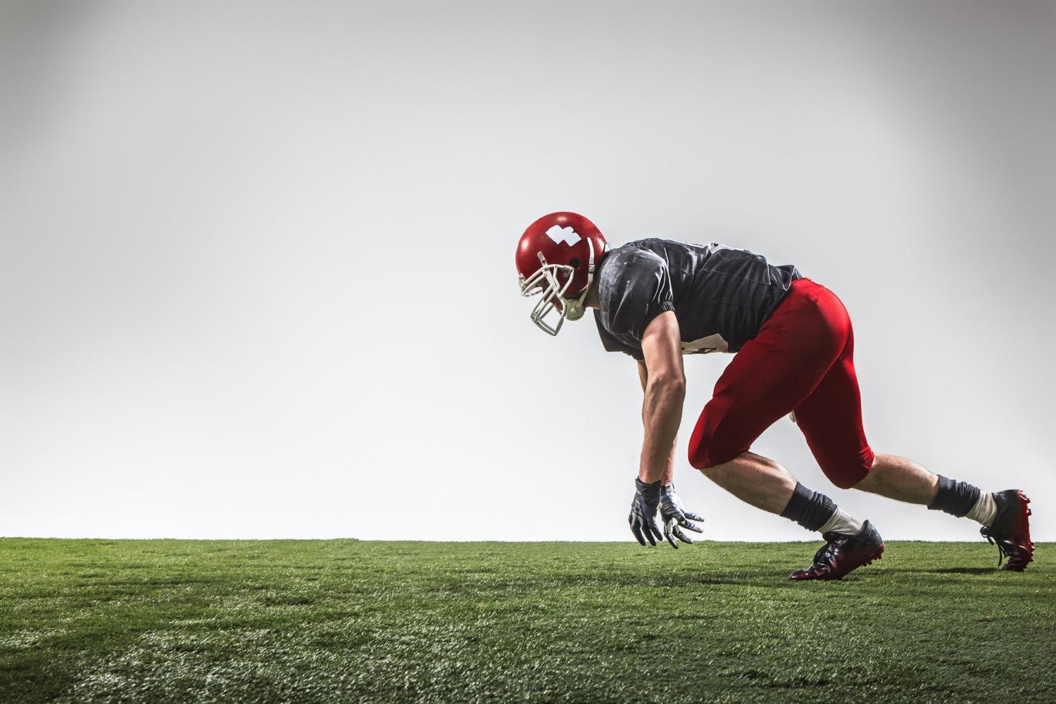 american football gridiron player on green grass practice session