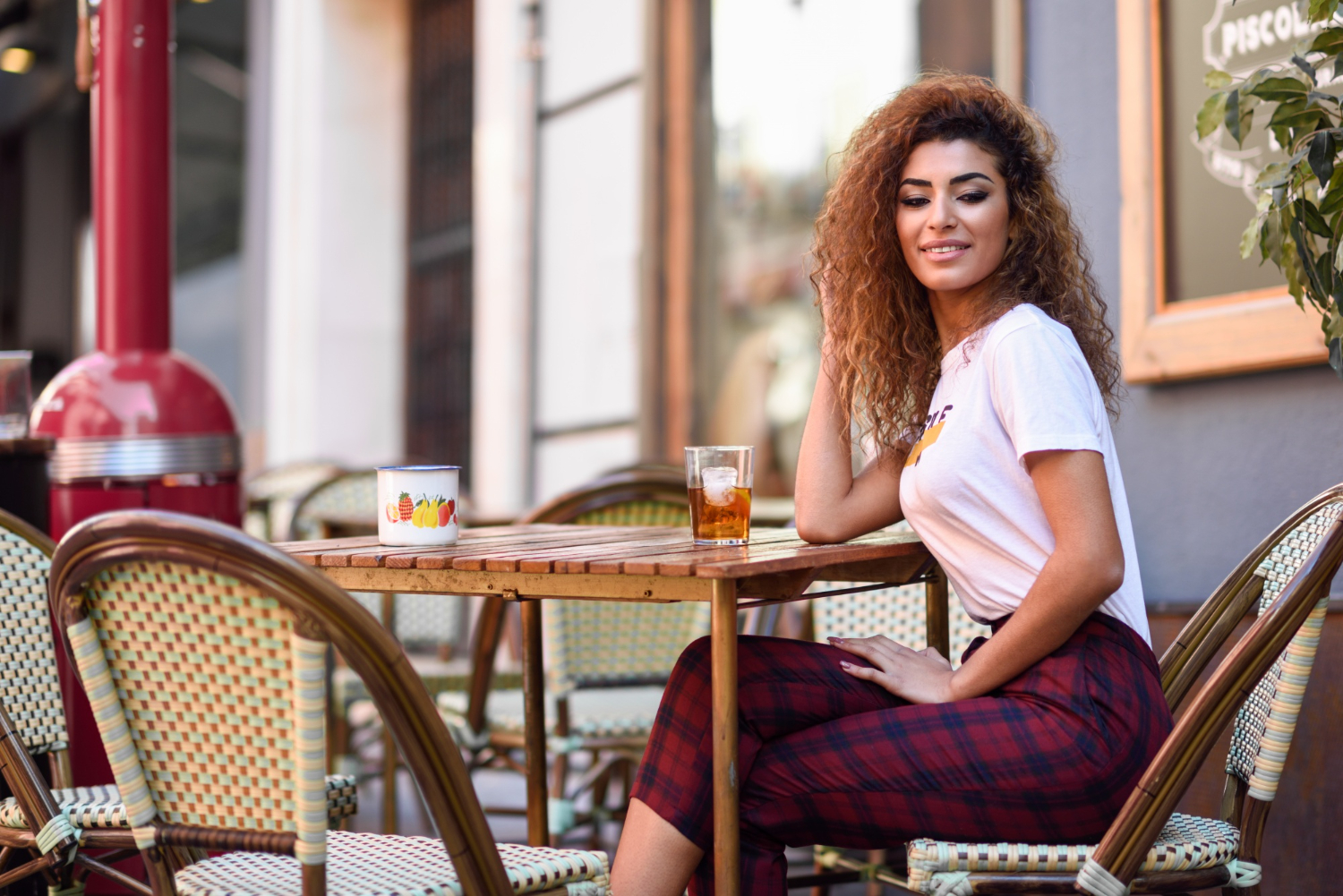 arab girl casual clothes drinking soda outdoors bar penelope