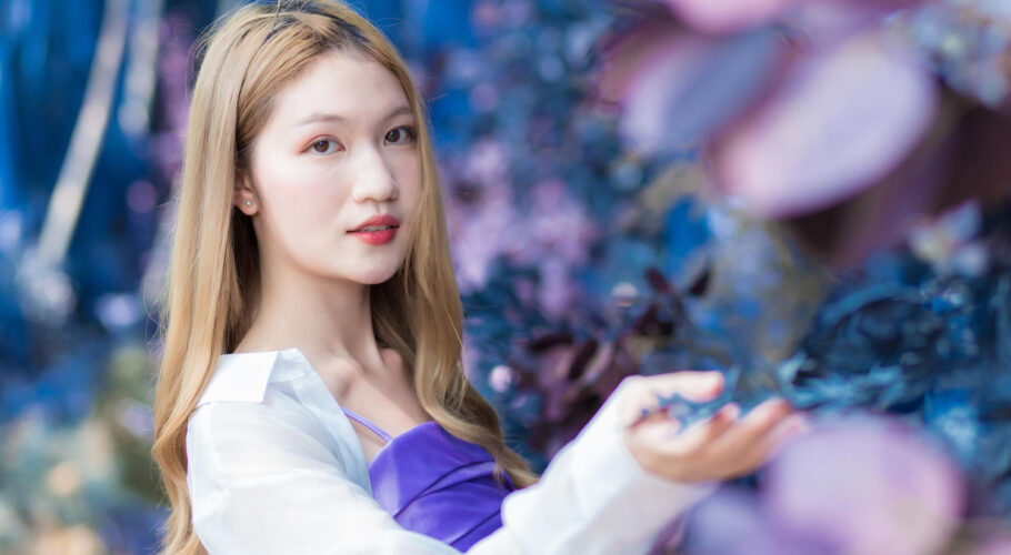 asian beautiful woman who bronze haired wears white shirt purple shirt smiles happily in china