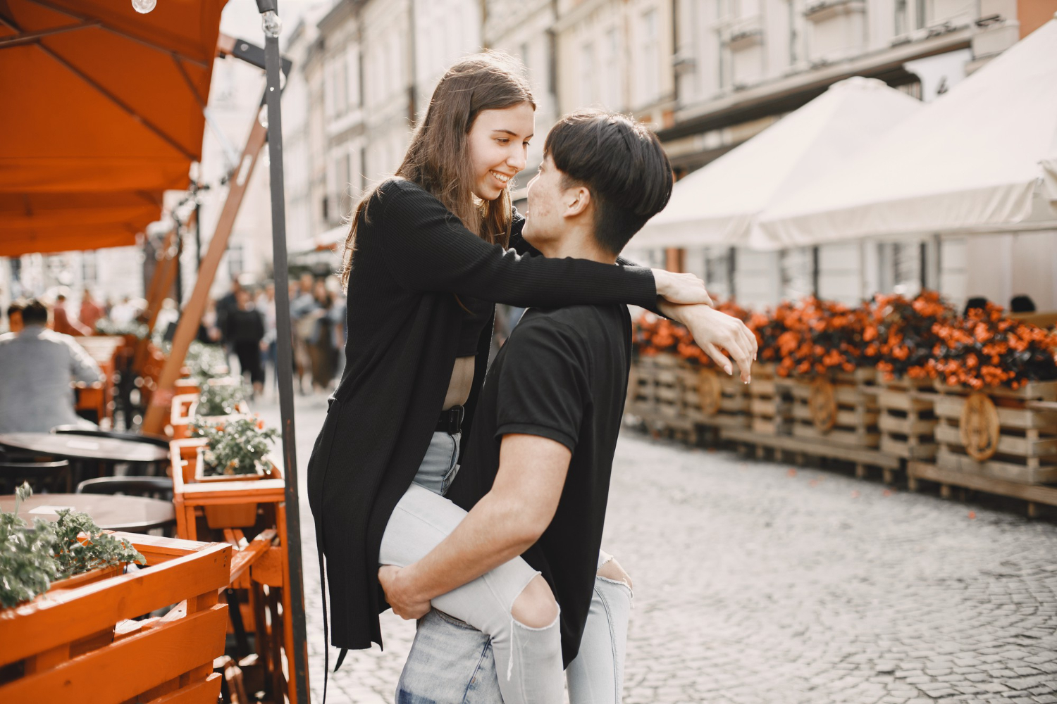 asian boy his caucasian girlfriend casual wear standing street couple hugging each other while walking together city