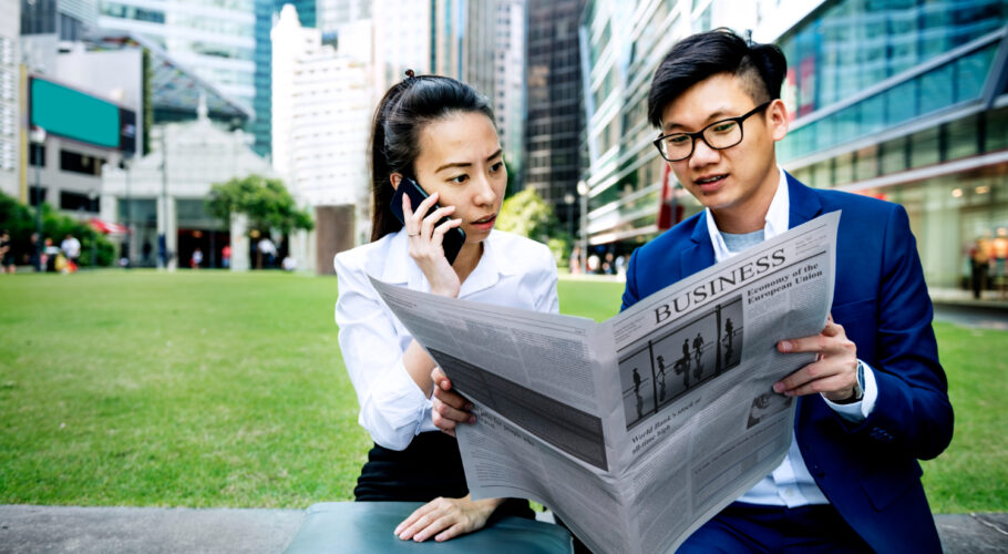 asian business people reading newspaper china entrepreneurs