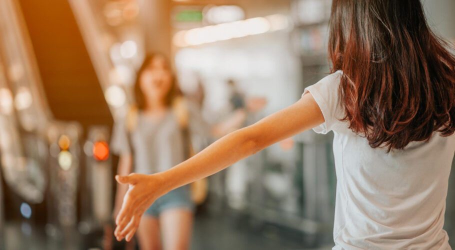 asian girl will be embracing friends from abroad airports concept airports hug