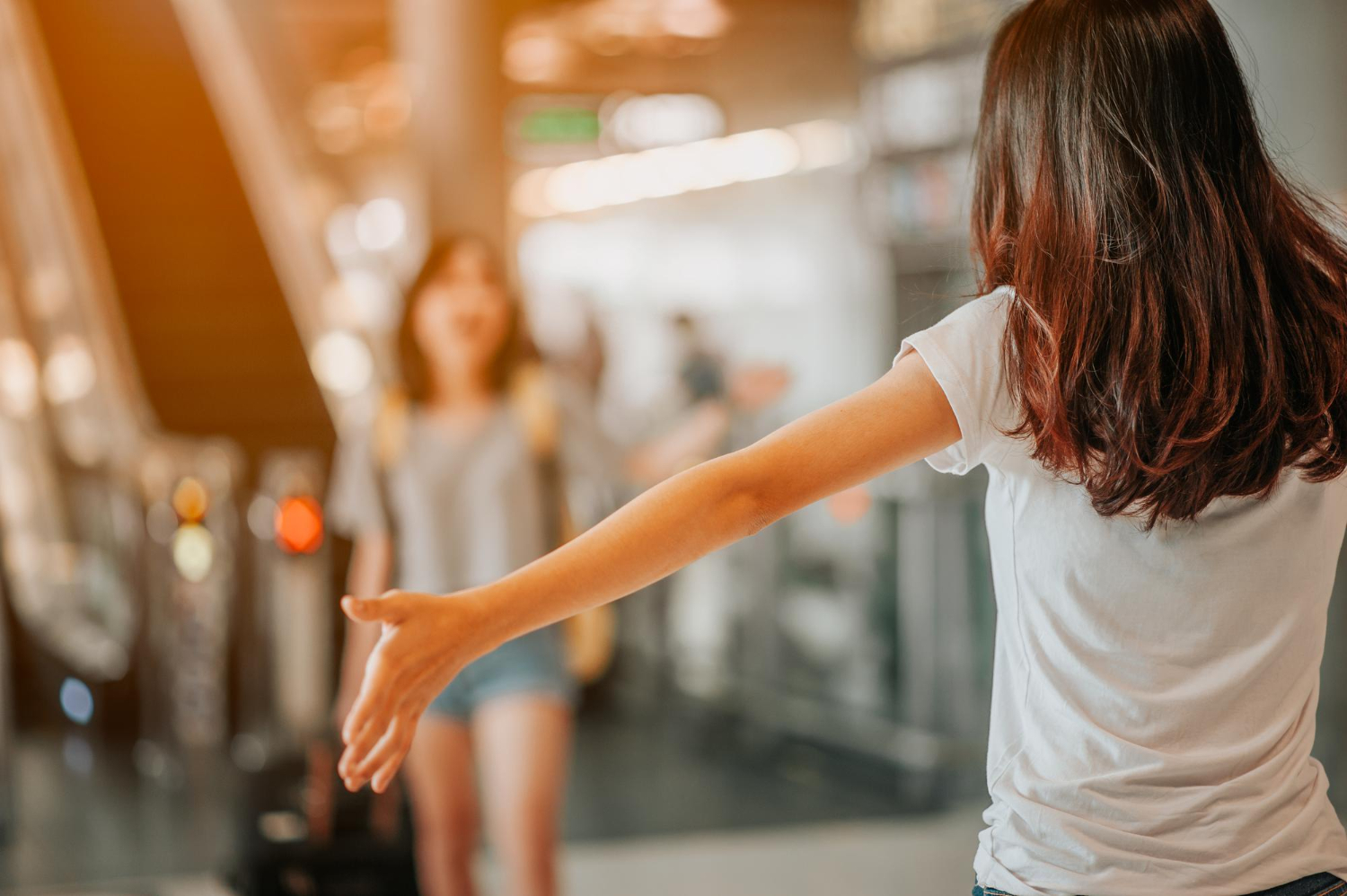 asian girl will be embracing friends from abroad airports concept airports hug