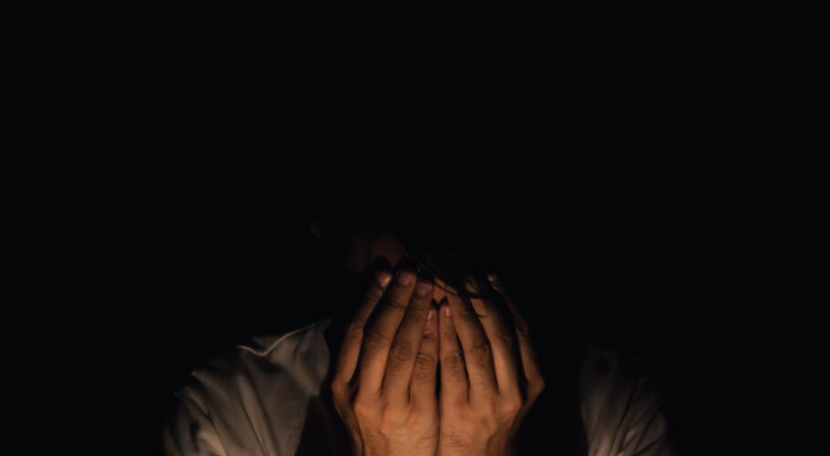 miserable depressed man sitting alone dark background depression mental health concept