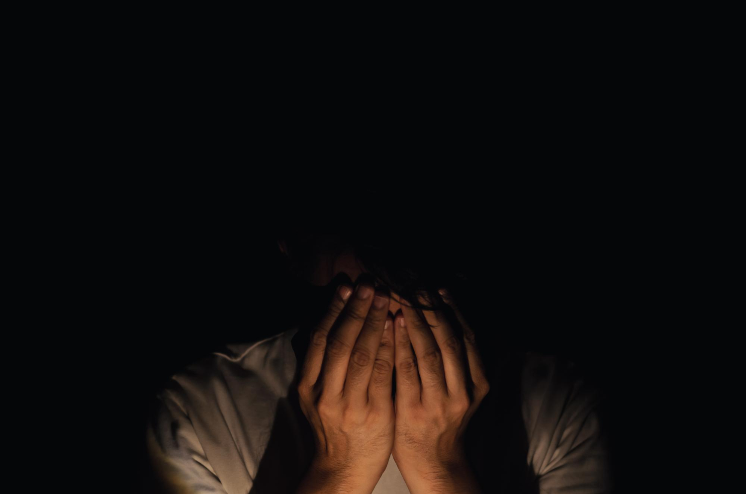 miserable depressed man sitting alone dark background depression mental health concept