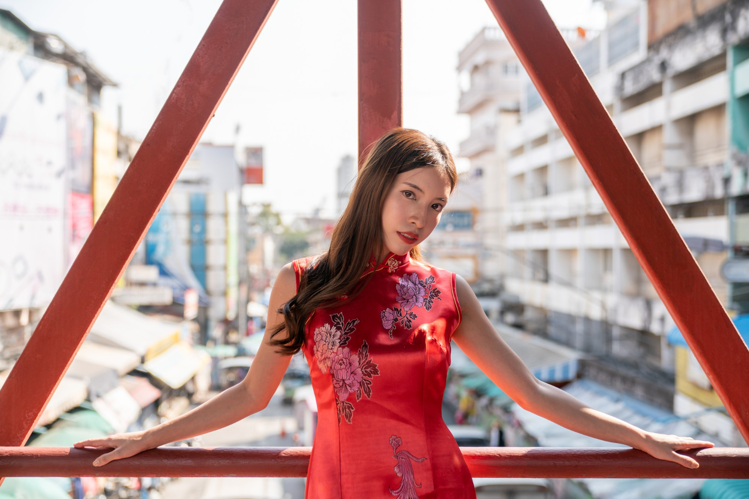 asian woman wearing red cheongsam qipao dress in chinatown for chinese new year looking seductive