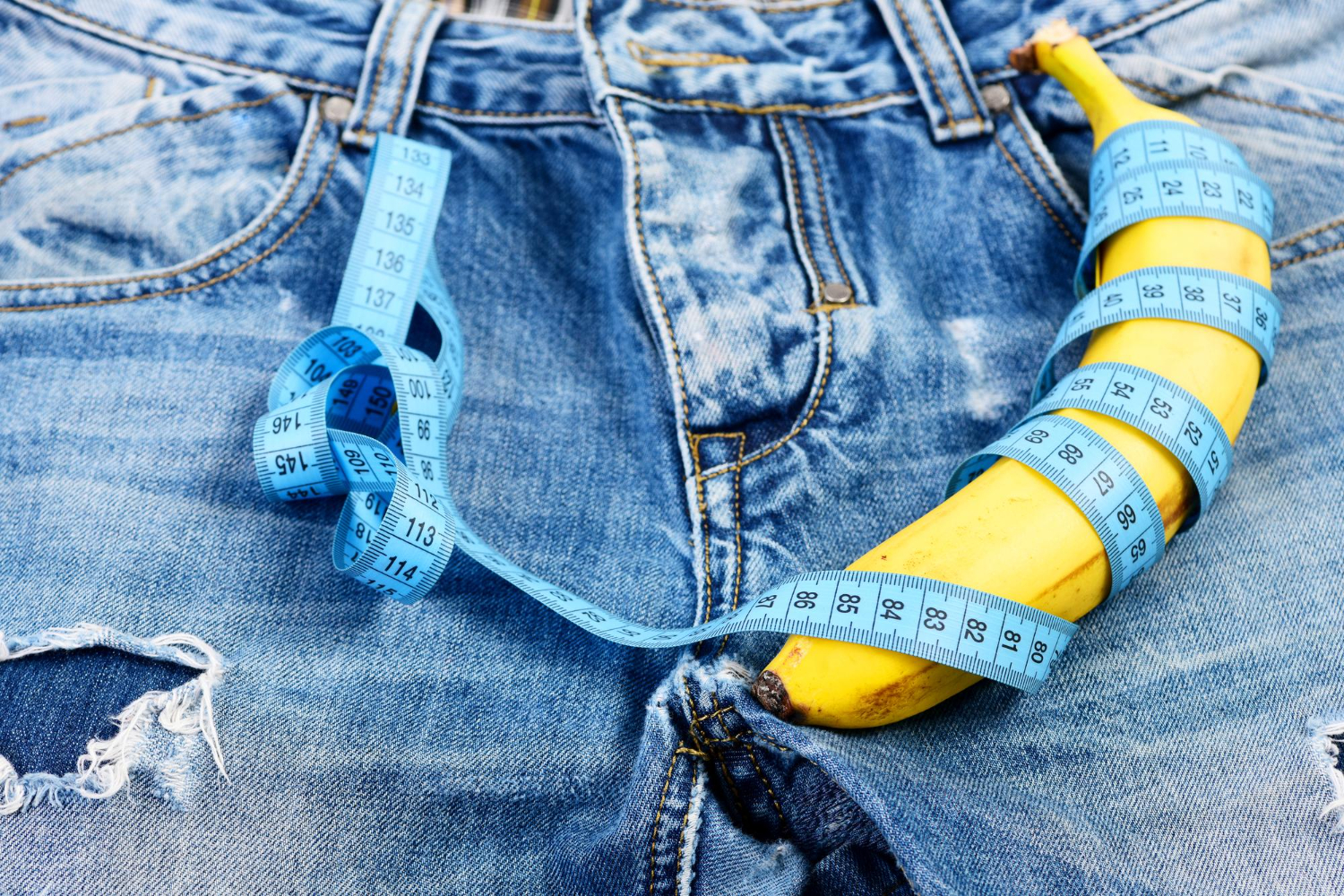 banana wrapped with blue measure tape jeans crotch