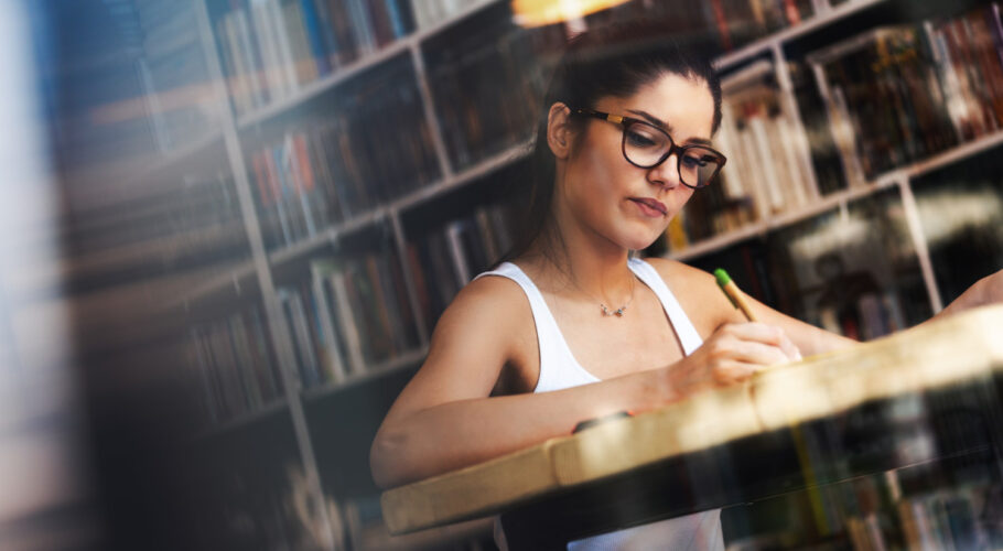 beautiful happy student girl studying reading book home