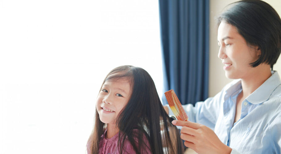 beautiful little asian child girl with long hair mom dressed up smooth hair morning room