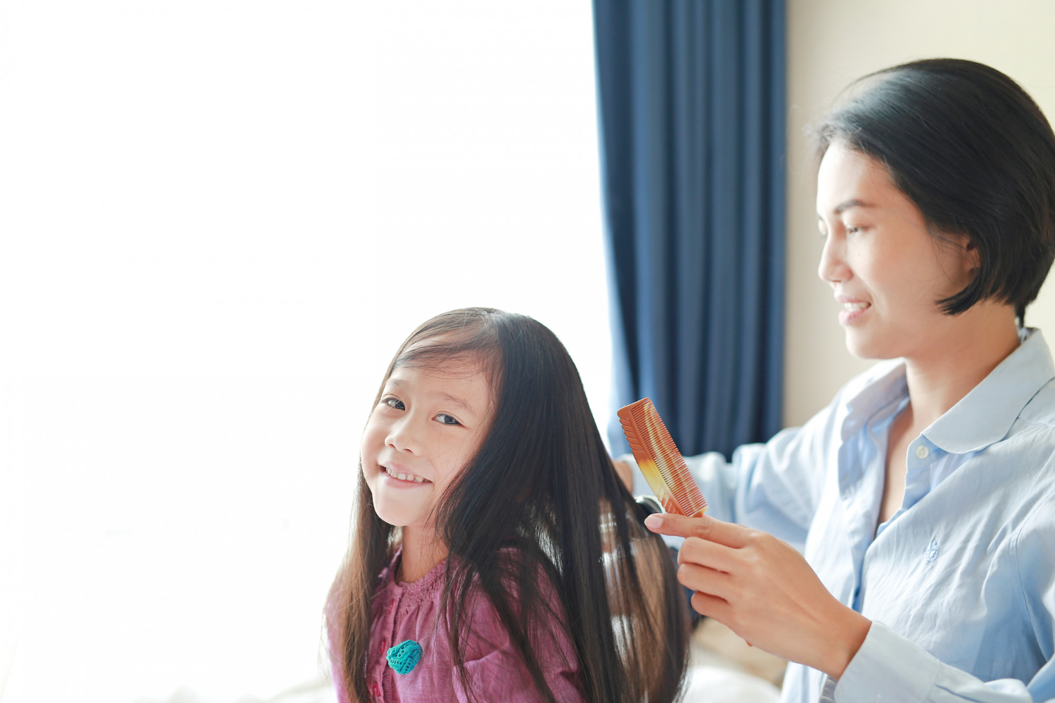 beautiful little asian child girl with long hair mom dressed up smooth hair morning room