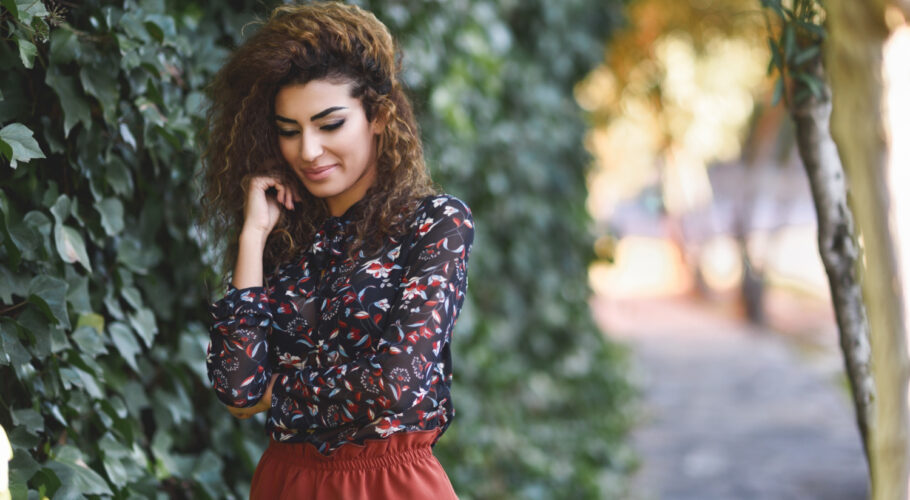 beautiful young arabic woman with black curly hairstyle