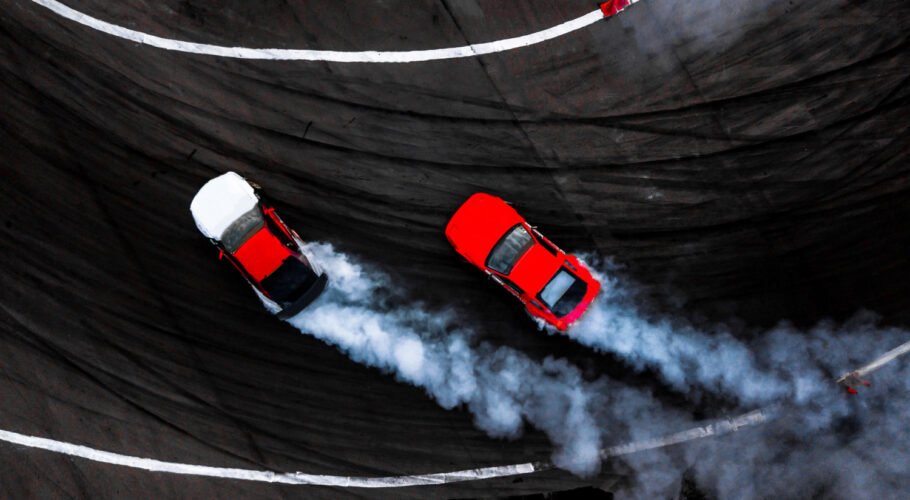 car drift battle two car drifting battle race track with smoke aerial view