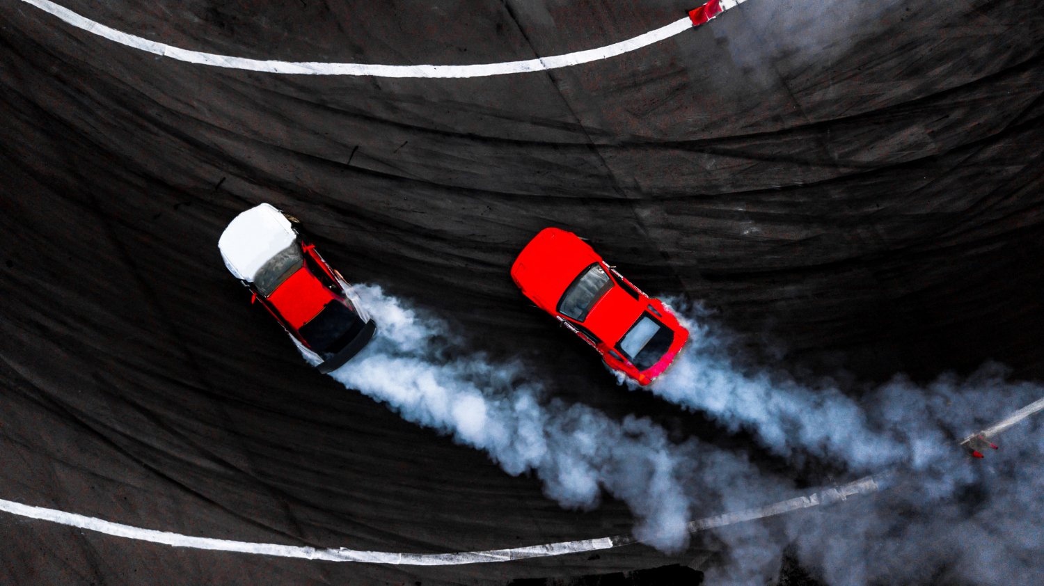 car drift battle two car drifting battle race track with smoke aerial view