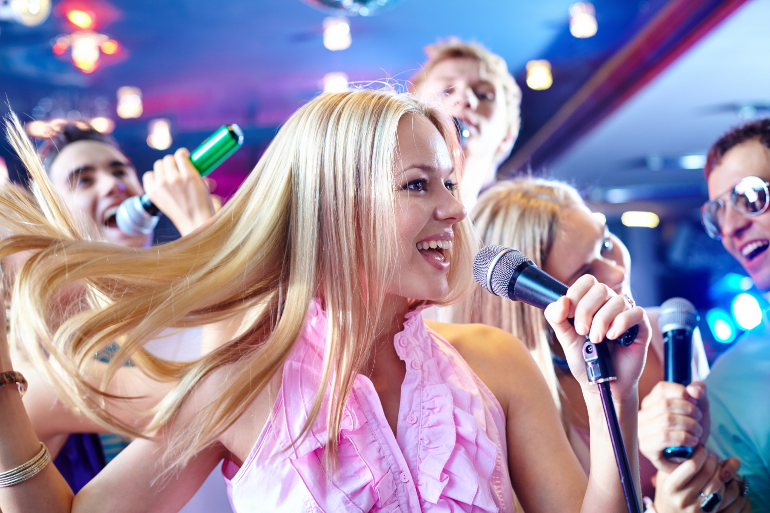 cheerful woman singing karaoke at a house party