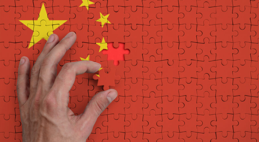 china flag is depicted puzzle which mans hand completes fold