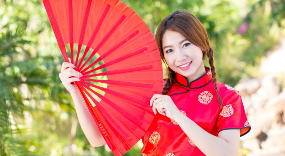 chinese girl with dress traditional cheongsam in a chinese garden
