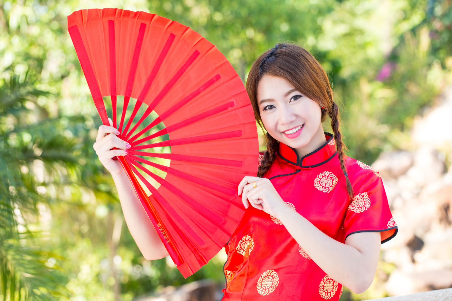 chinese girl with dress traditional cheongsam in a chinese garden