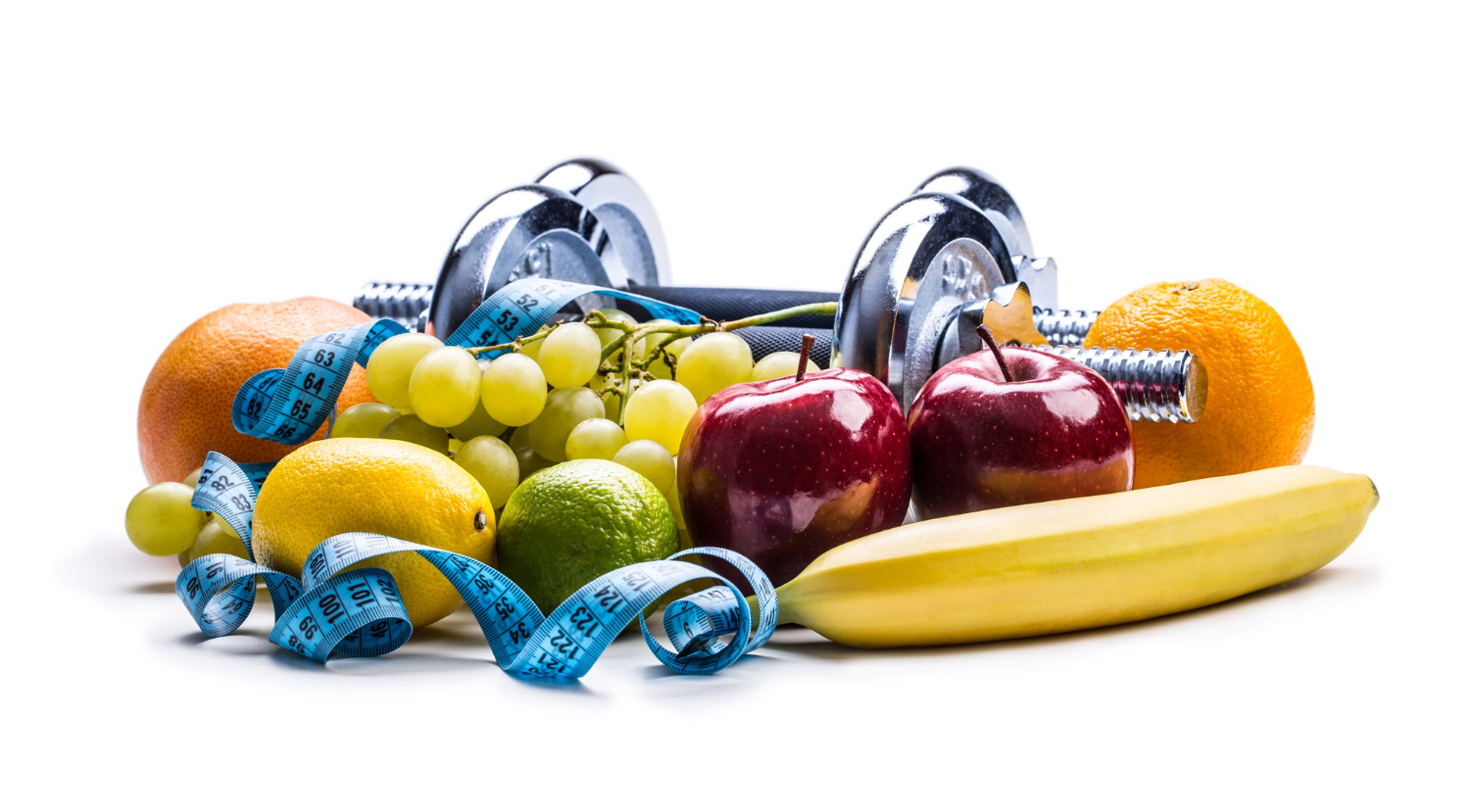 chrome dumbbells surrounded with healthy fruits and measuring tape