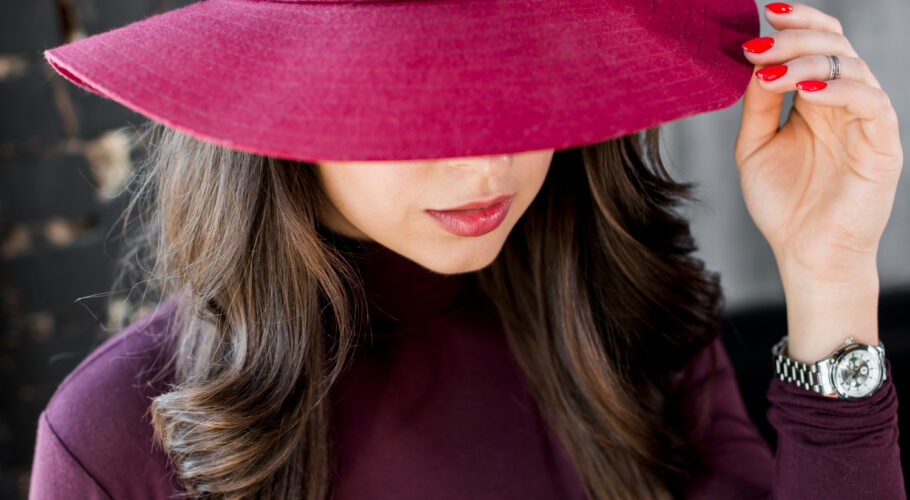 close up beautiful young woman with pink hat red polo neck