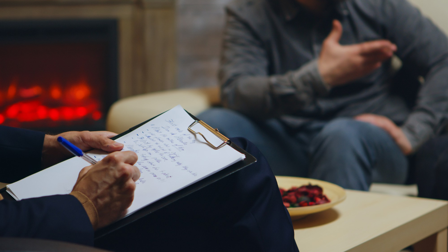 close up psychologist writing notes while couple yelling relationship guidance