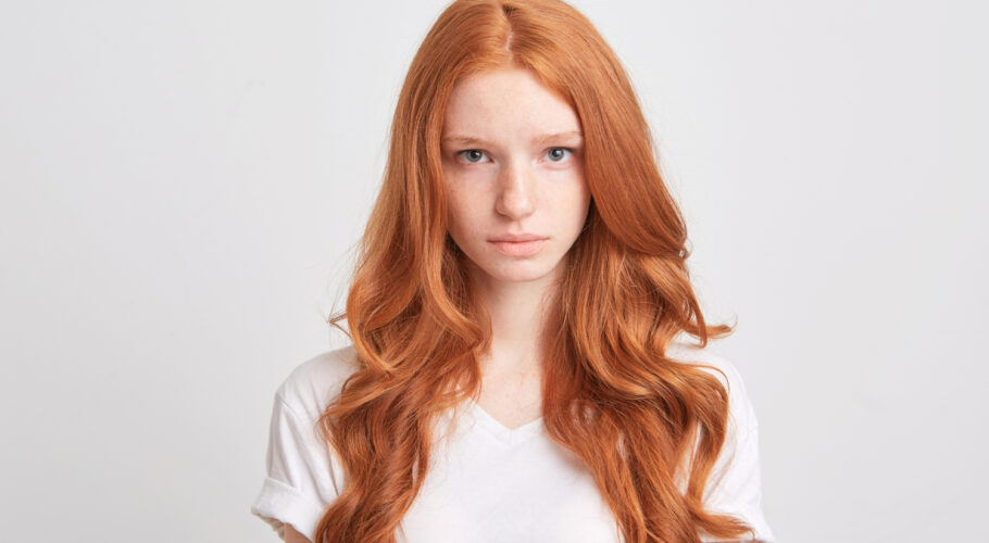 beautiful redhead ginger young woman with wavy long hair and freckles