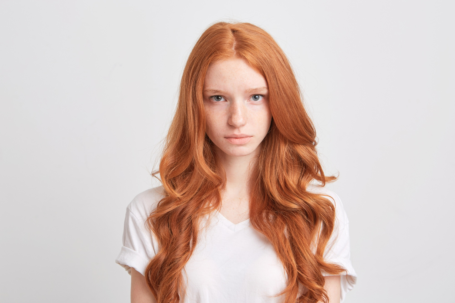 beautiful redhead ginger young woman with wavy long hair and freckles