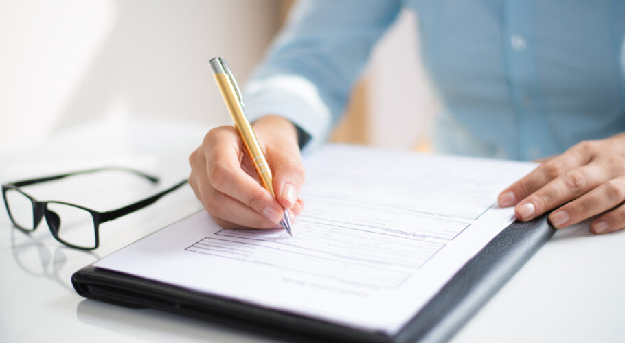 closeup business woman making notes document spelling mistakes application form