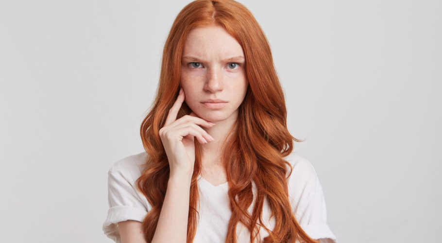 closeup depressed upset redhead young woman kathryn with long wavy hair redhead