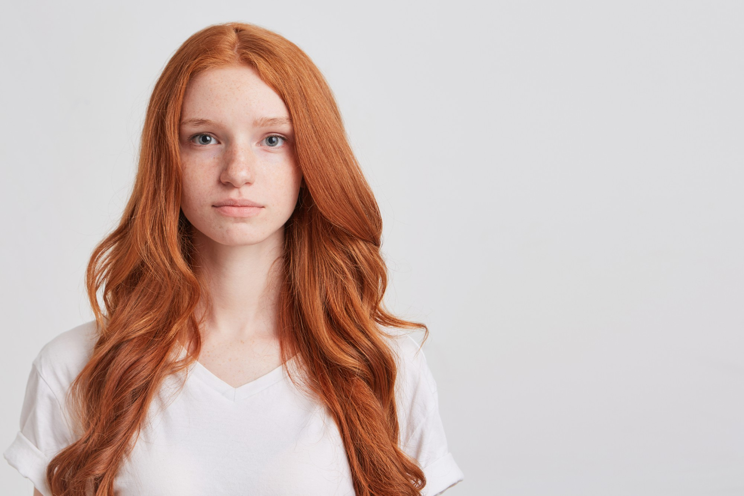 closeup serious beautiful redhead young woman kathryn with long wavy hair freckles wears shirt