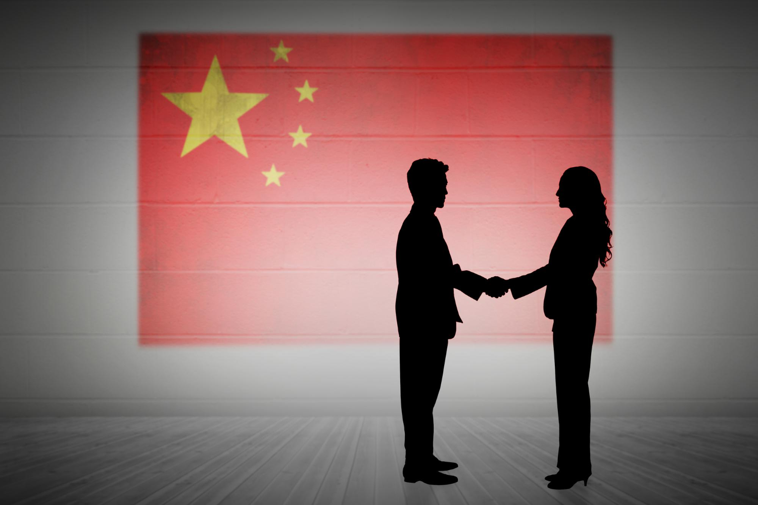 composite image silhouette business people shaking hands between china and western counterparts