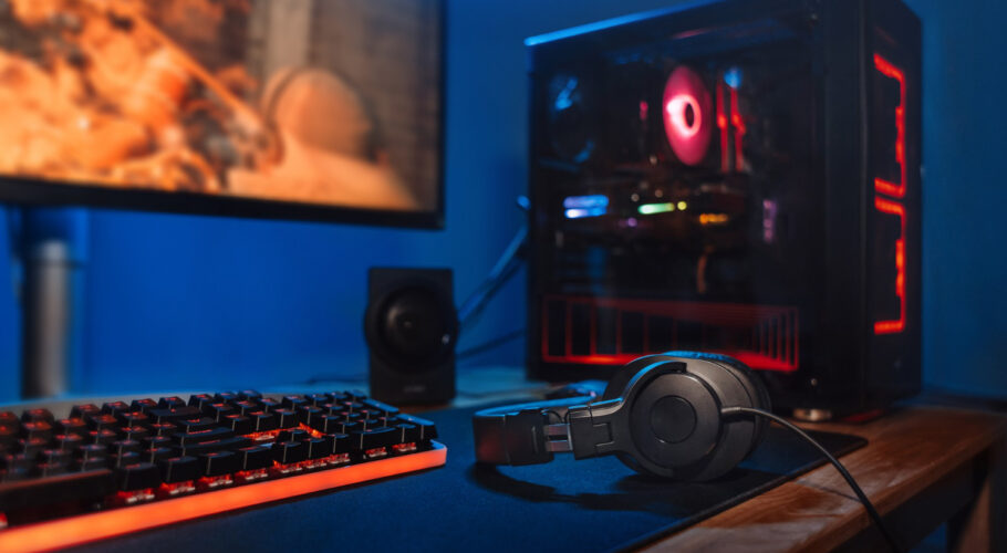 computer gamer workplace with new game keyboard mouse headphones modern pc with blur blue red neon light