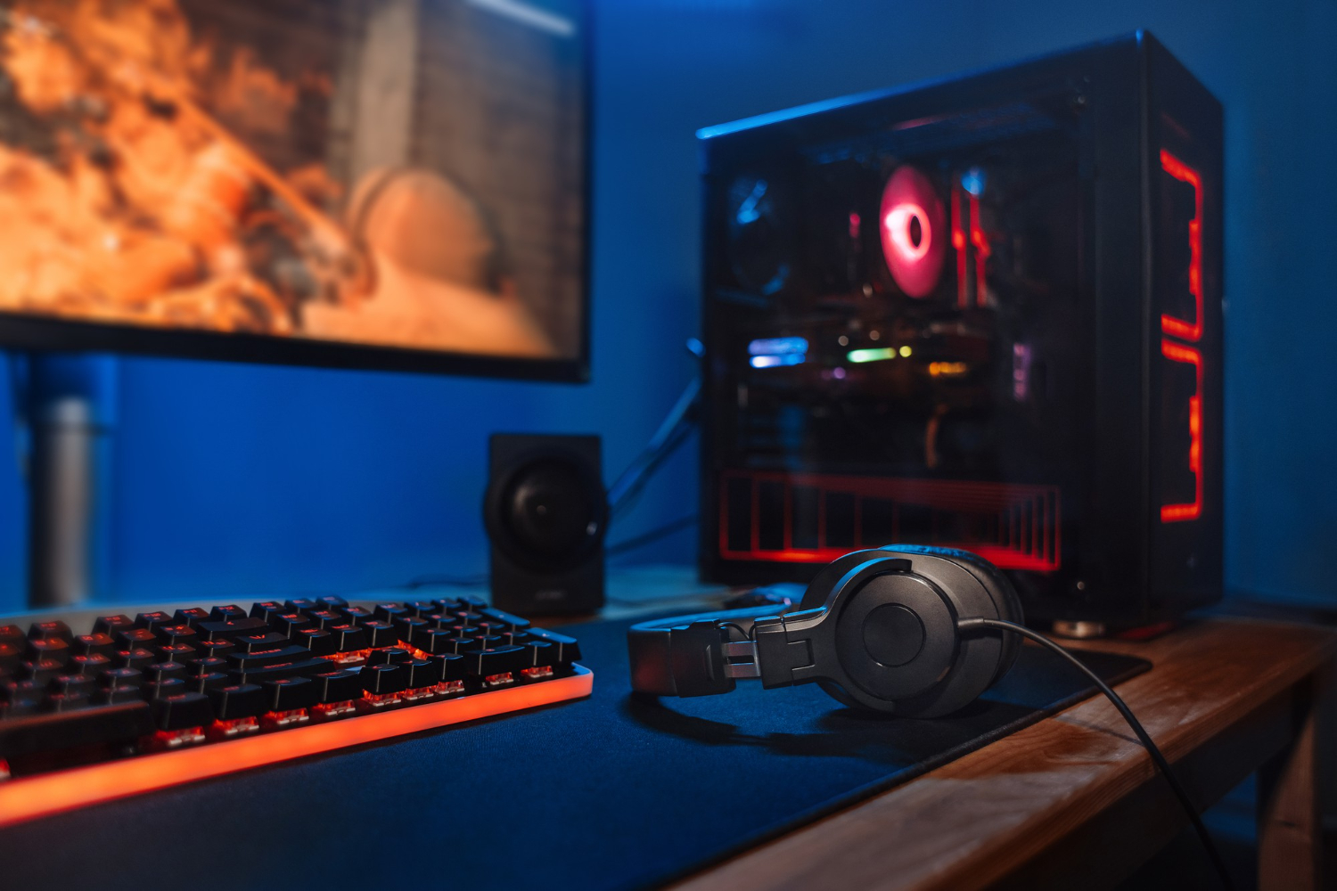 computer gamer workplace with new game keyboard mouse headphones modern pc with blur blue red neon light