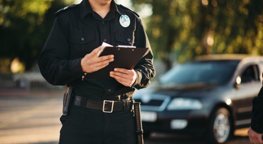 cop with notebook comes in to check domestic dispute