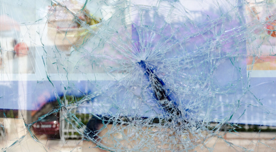 cracked broken glass window looking to the street outside