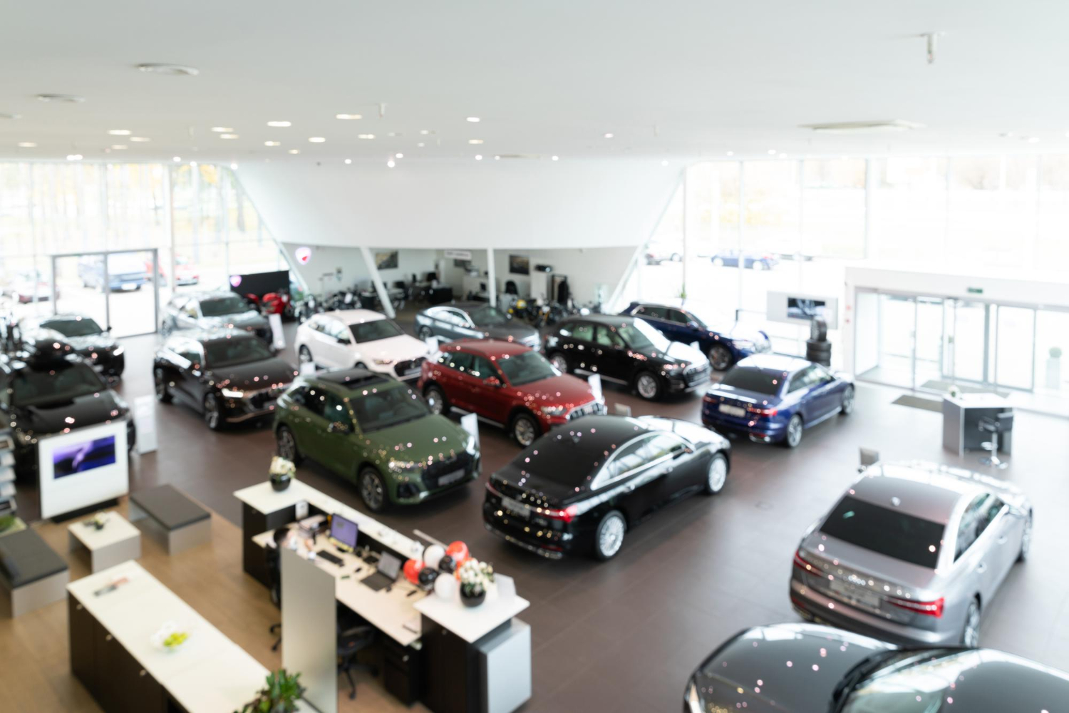 car dealership showroom with premium cars panorama with blur