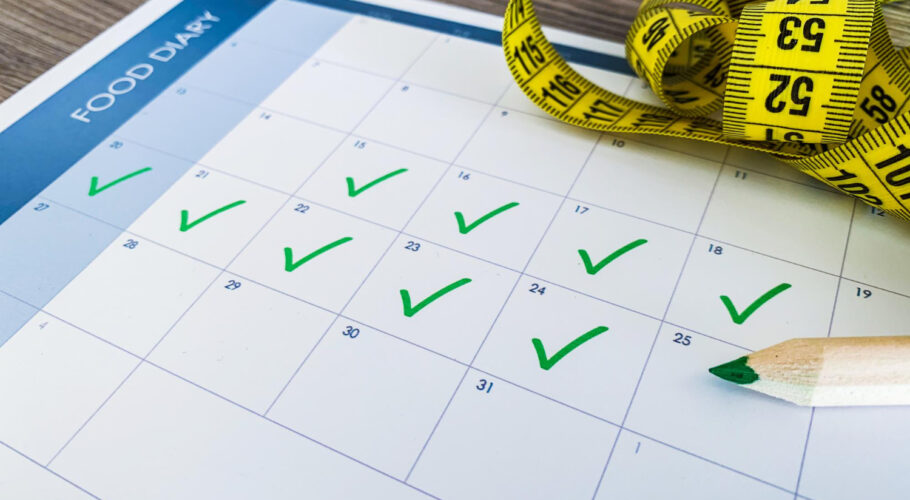 diet plan concept measuring tape diet plan on wooden background