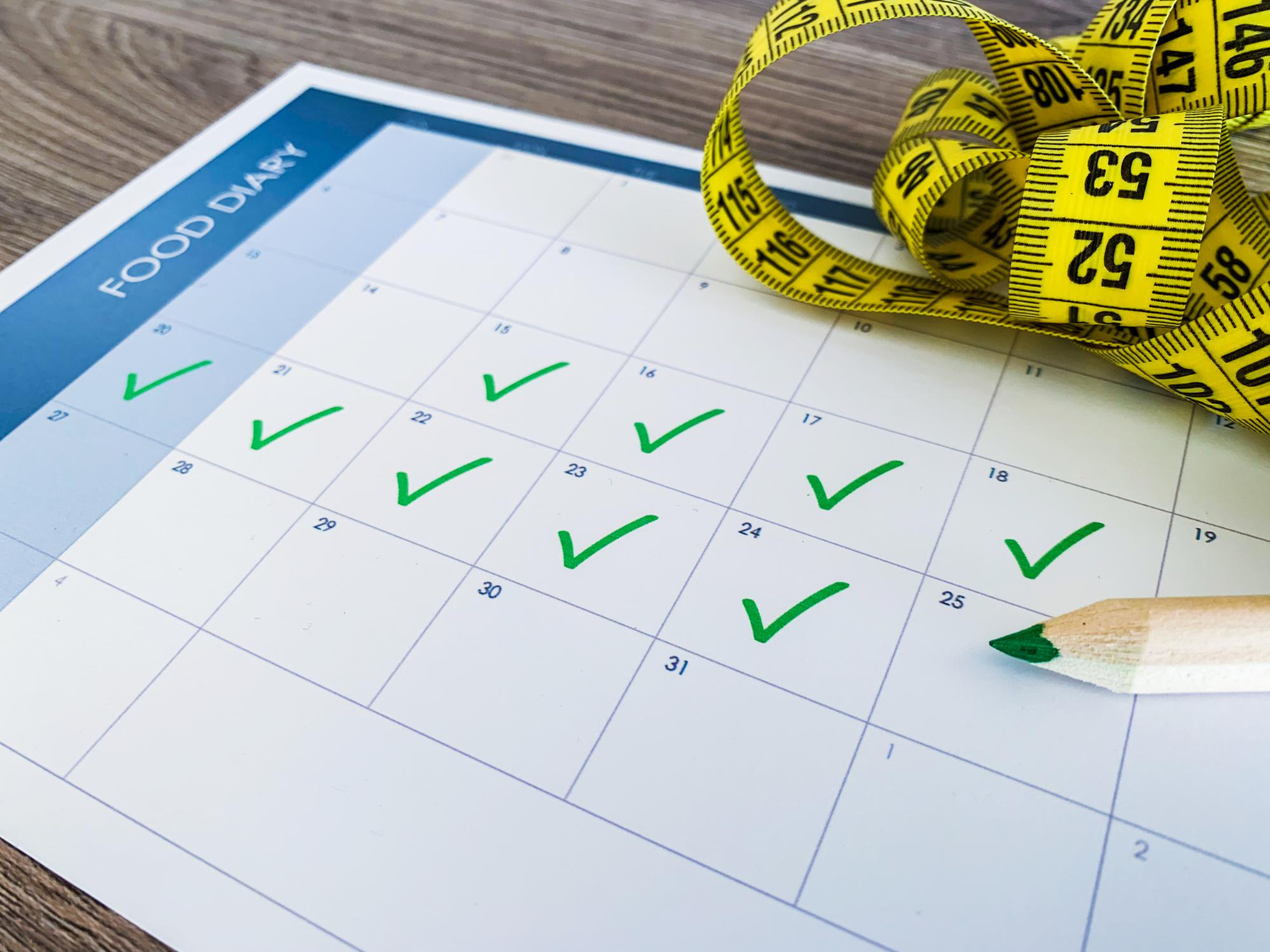 diet plan concept measuring tape diet plan on wooden background