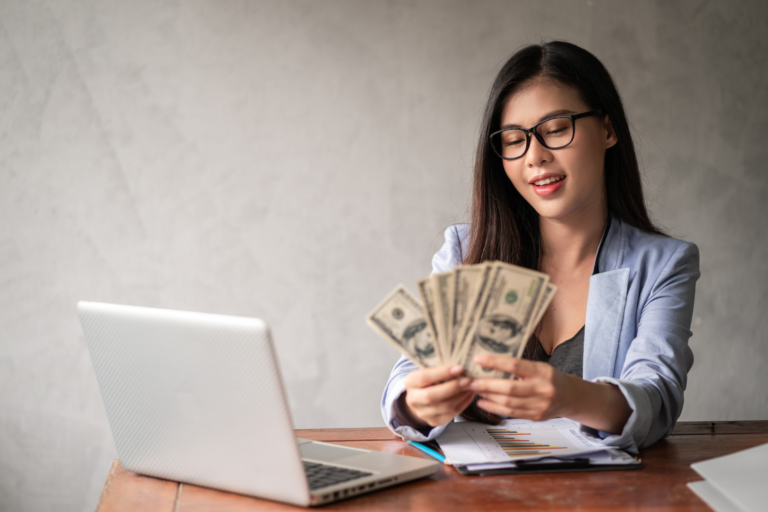 dollar businesswoman hand asia woman is working from home office glad get dollar money from work