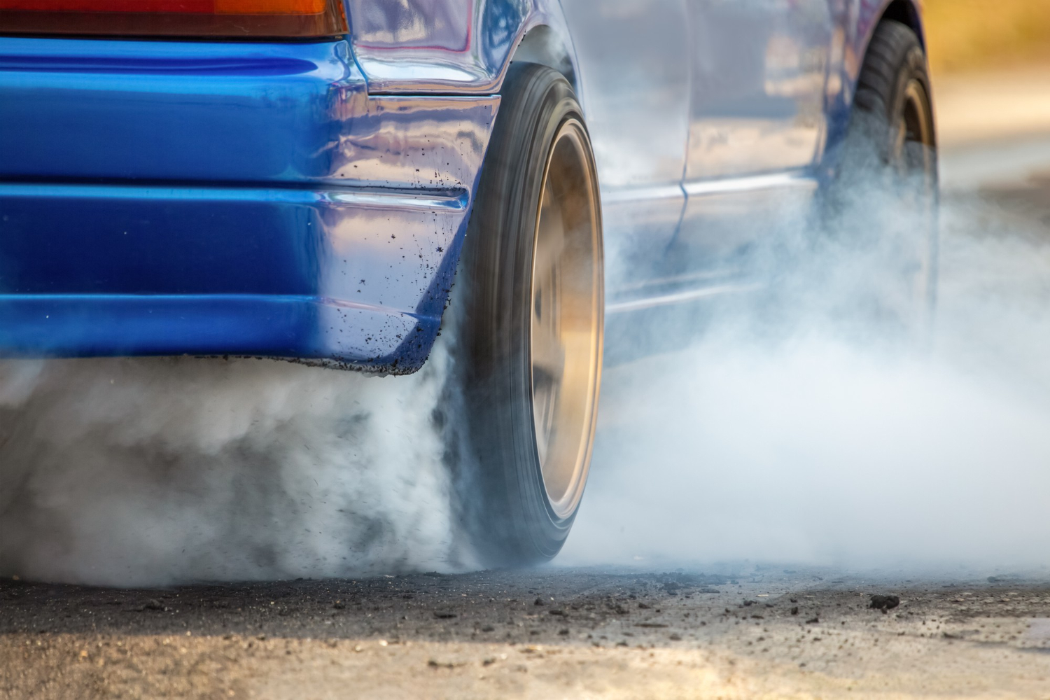 drag racing car burns rubber off its tires preparation race