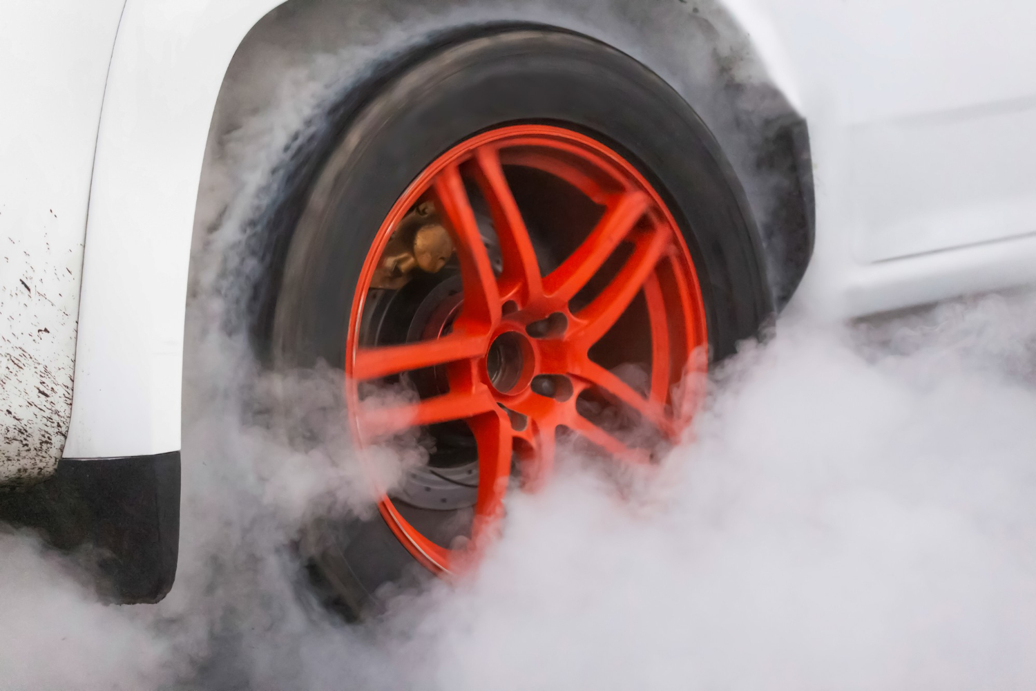 drag racing car burns rubber off its tires preparation race