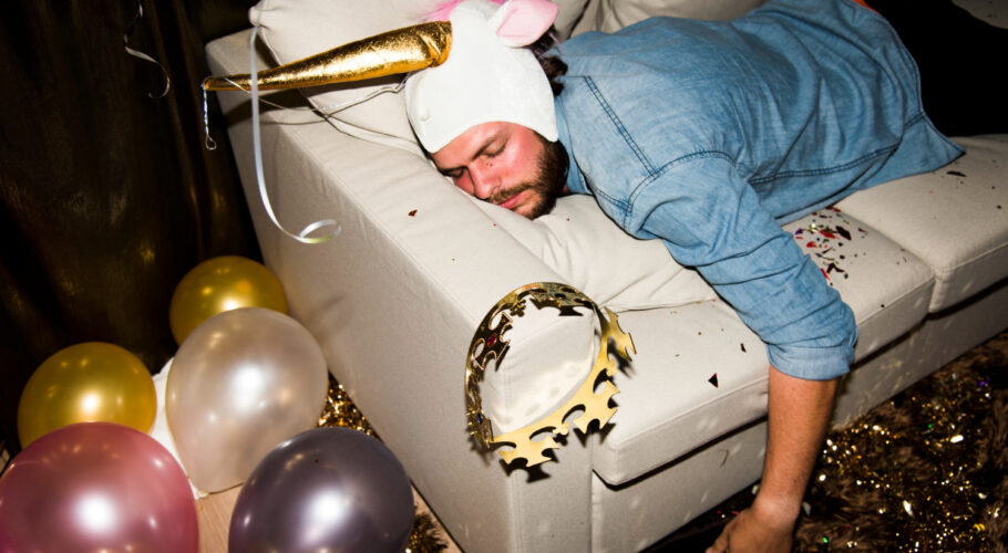 drunk people at a party fallen asleep on couch