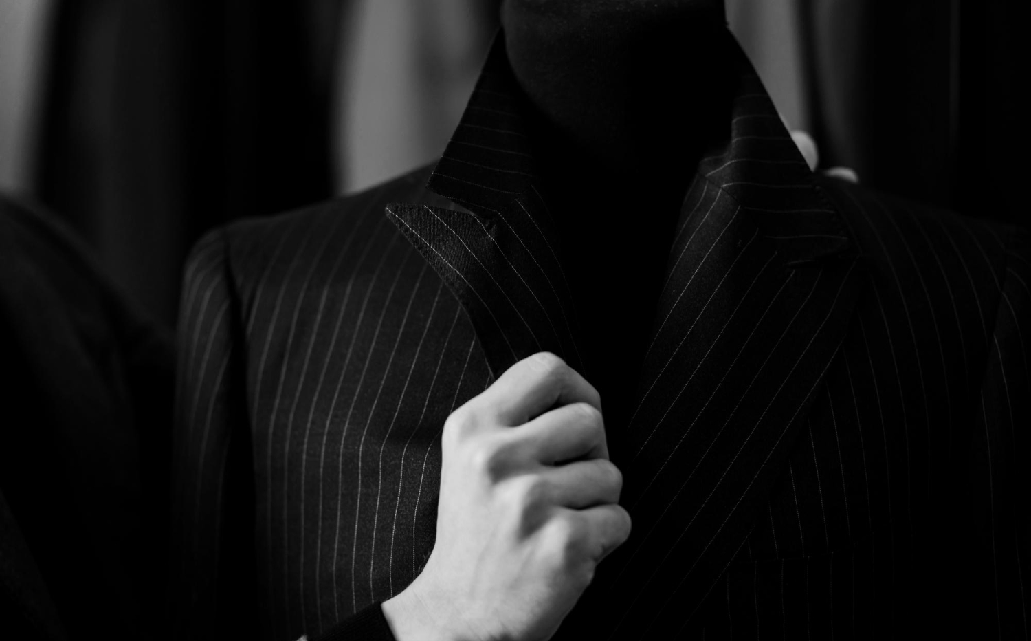 elegant mens suit buyer holds costume collar