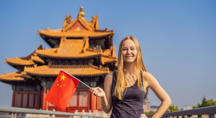 enjoying vacation china young woman with national chinese flag forbidden city travel china