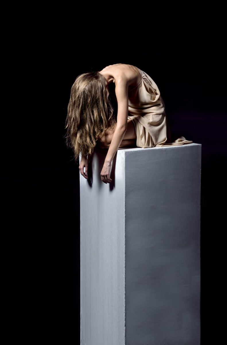 exhausted woman sitting stone pedestal